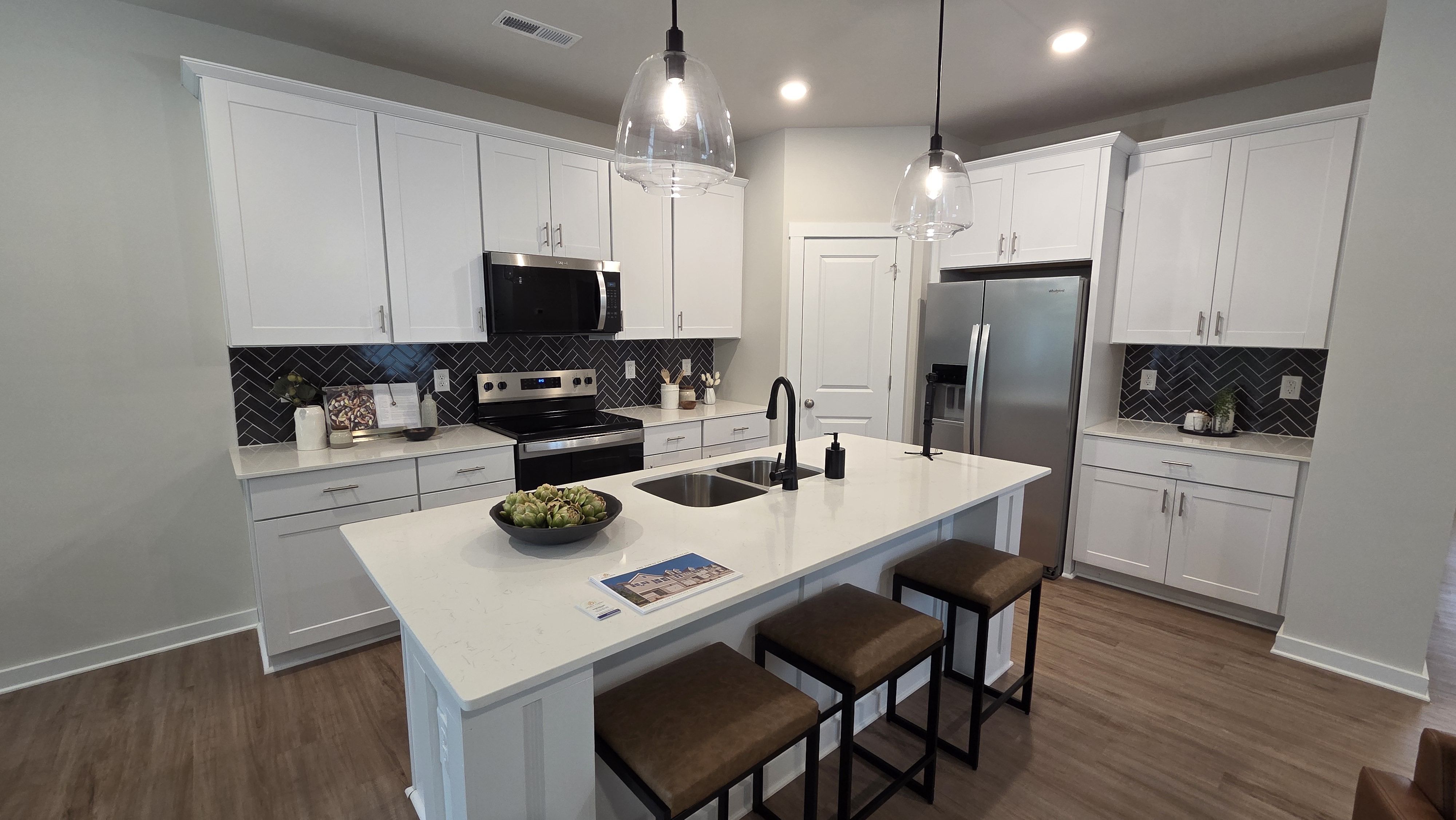 Townhome kitchen with quartz countertops and luxury vinyl plank flooring at The Towns at Kings Mountain